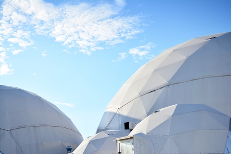 Geodesic dome on a background of blue skyの写真素材