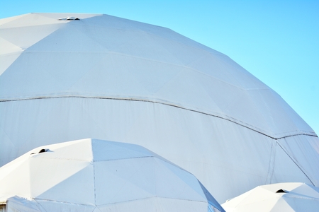 Geodesic dome on a background of blue skyの写真素材