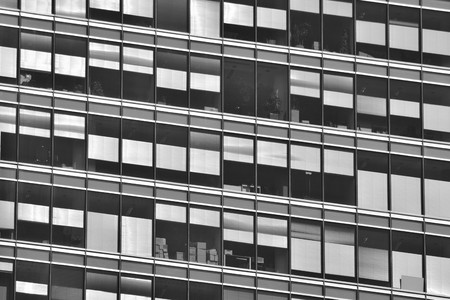 Modern office building wall made of steel and glass. Black and white.