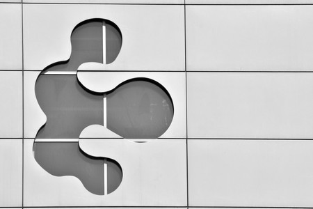 Modern office building wall made of steel and glass. Black and white.
