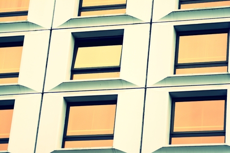 Modern office building facade abstract fragment, shiny windows in steel structure, retro stylized...