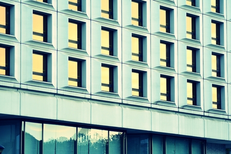 Modern office building facade abstract fragment, shiny windows in steel structure, retro stylized...