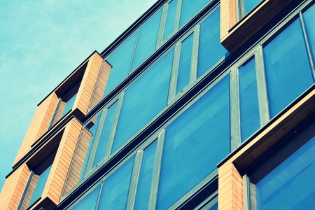 Modern office building facade abstract fragment, shiny windows in steel structure, retro stylized...