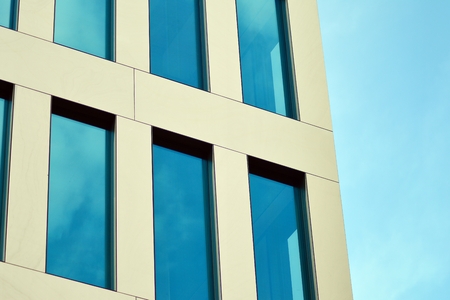 Abstract fragment of contemporary architecture, walls made of glass and concrete. Glass curtain wall of modern office buildingの写真素材