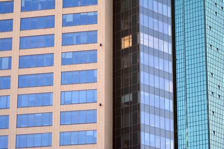 Abstract fragment of contemporary architecture, walls made of glass and concrete. Glass curtain wall...