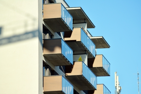 Fragment of a building with windows and balconies. Modern home with many flats.の写真素材
