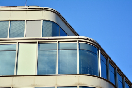 Facade fragment of a modern office building. Exterior of glass wall with abstract texture.