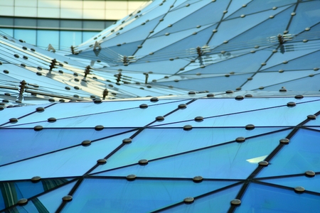 Facade fragment of a modern office building. Exterior of glass wall with abstract texture.の写真素材
