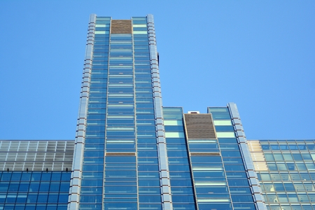 Facade fragment of a modern office building. Exterior of glass wall with abstract texture.