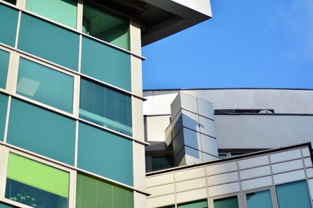 Facade fragment of a modern office building. Exterior of glass wall with abstract texture.