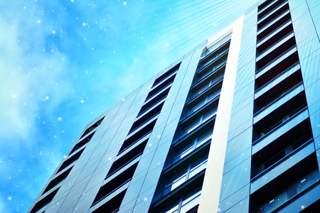 Sky with the stars above a multi-storey residential building.