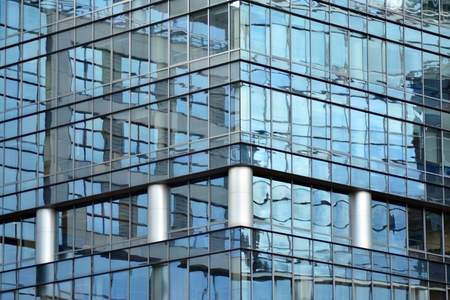 Modern building with reflected sky and cloud in glass window