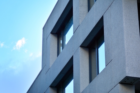 Abstract fragment of modern architecture, walls made of glass and concrete.の写真素材