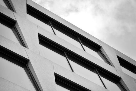 Abstract fragment of modern architecture, walls made of glass and concrete. Black and white.の写真素材