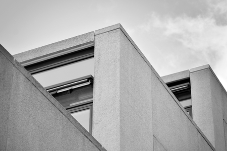 Abstract fragment of modern architecture, walls made of glass and concrete. Black and white.