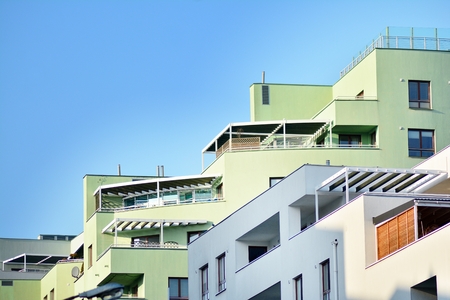 Modern apartment buildings on a sunny day with a blue sky. Facade of a modern apartment building