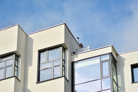 Modern apartment buildings on a sunny day with a blue sky. Facade of a modern apartment building