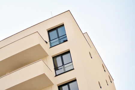 Modern white building with balcony on a blue sky