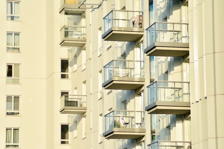 Modern white building with balcony on a blue skyの写真素材