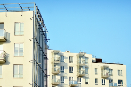Modern white building with balcony on a blue skyの写真素材