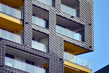 Modern multi-storey luxury housing concept. Modern apartment building with blue sky and clouds.の写真素材