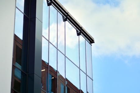 Sky reflected in a modern building glass facade