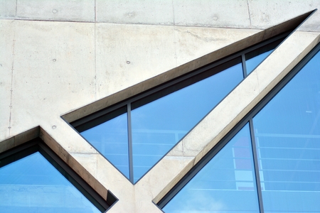 Abstract image of looking up at modern glass and concrete building. Architectural exterior detail of office building.の写真素材
