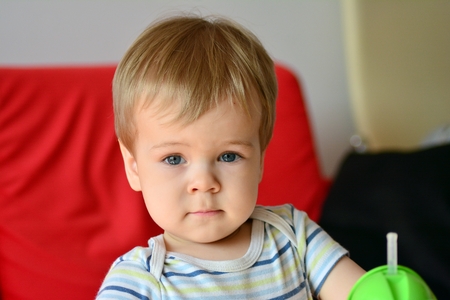 Cute boy with blond hair and blue eyesの写真素材