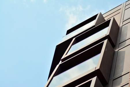 European modern residential architecture. Fragment of a modern apartment building in front. Very...