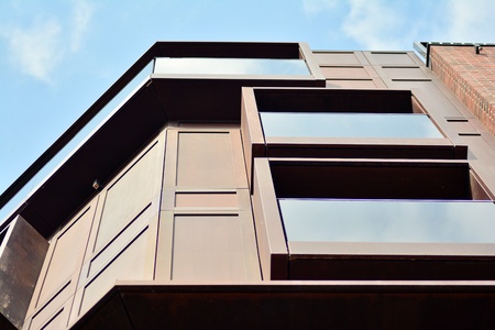 European modern residential architecture. Fragment of a modern apartment building in front. Very modern apartment house.の写真素材