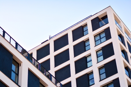 Modern and new apartment building. Multistoried modern, new and stylish living block of flats.の写真素材