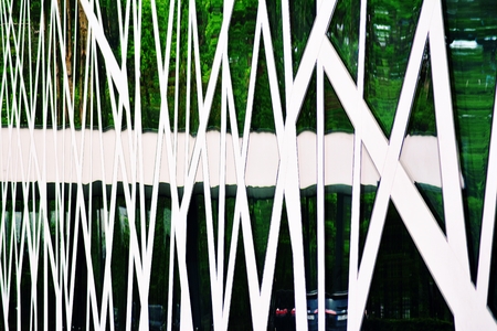 Abstract image of looking up at modern glass and concrete building. Architectural exterior detail of...