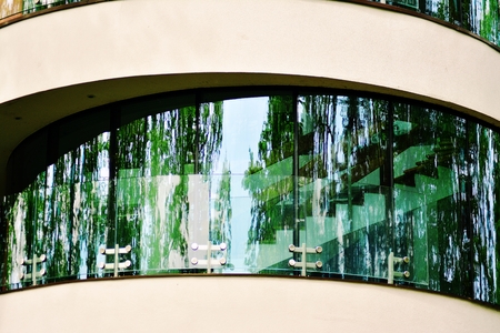 Abstract image of looking up at modern glass and concrete building. Architectural exterior detail of office building.の写真素材