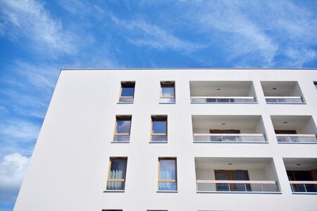 Modern multi-storey luxury housing concept. Modern apartment building with blue sky and clouds.