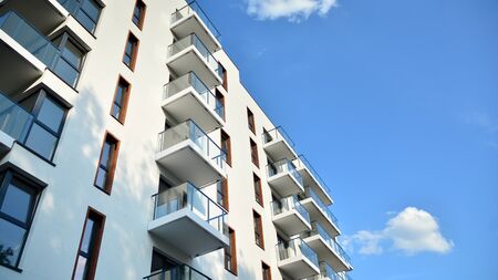 Contemporary residential building exterior in the daylight. Modern apartment buildings on a sunny day with a blue sky. Facade of a modern apartment buildingの写真素材