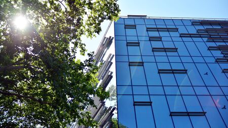 Modern office building with reflection in windows of building. New office building in the city center.の写真素材