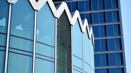 Modern office building with reflection in windows of building. New office building in the city center.の写真素材