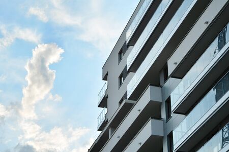 Contemporary residential building exterior in the daylight. Modern apartment buildings on a sunny day with a blue sky. Facade of a modern apartment buildingの写真素材