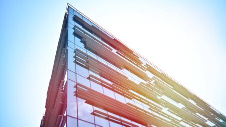 Modern office building detail, glass surface with sunlight