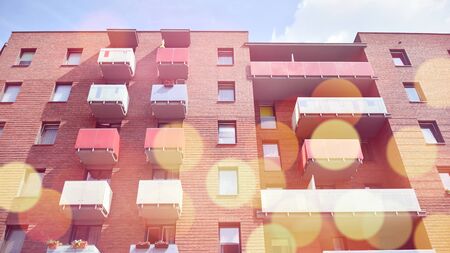 Modern apartment building detail, glass surface with sunlight