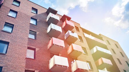 Modern apartment building detail, glass surface with sunlight