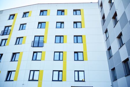Modern apartment buildings on a sunny day with a blue sky. Facade of a modern apartment buildingの写真素材