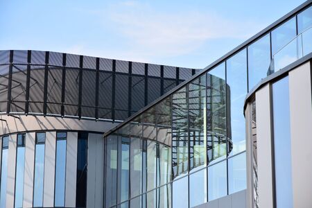 Facade fragment of a modern office building. Exterior of glass wall with abstract texture.