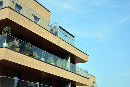 Modern apartment buildings on a sunny day with a blue sky. Facade of a modern apartment building