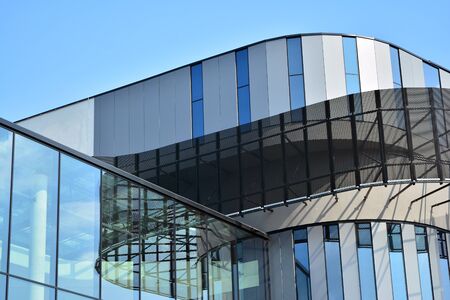 Facade fragment of a modern office building. Exterior of glass wall with abstract texture.の写真素材