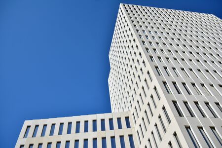Modern office building detail. Perspective view of geometric angular concrete windows on the facade...