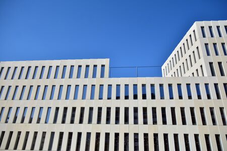Modern office building detail. Perspective view of geometric angular concrete windows on the facade...