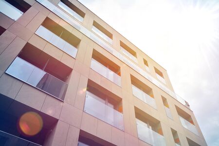 Modern apartment buildings on a sunny day with a blue sky. Facade of a modern apartment building.Glass surface with sunlight.の写真素材