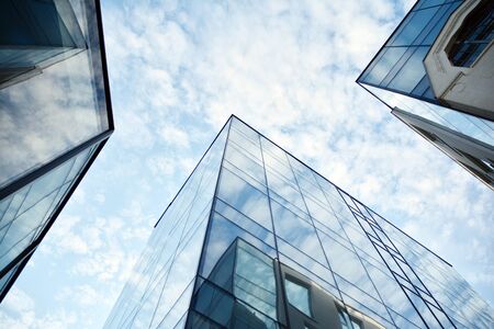 Panoramic and perspective wide angle view to steel light blue background of glass office building commercial modern city of future. Business concept of success industry tech architecture.の写真素材