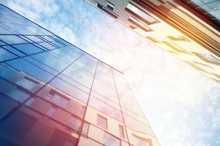 Modern office building detail, glass surface with sunlight